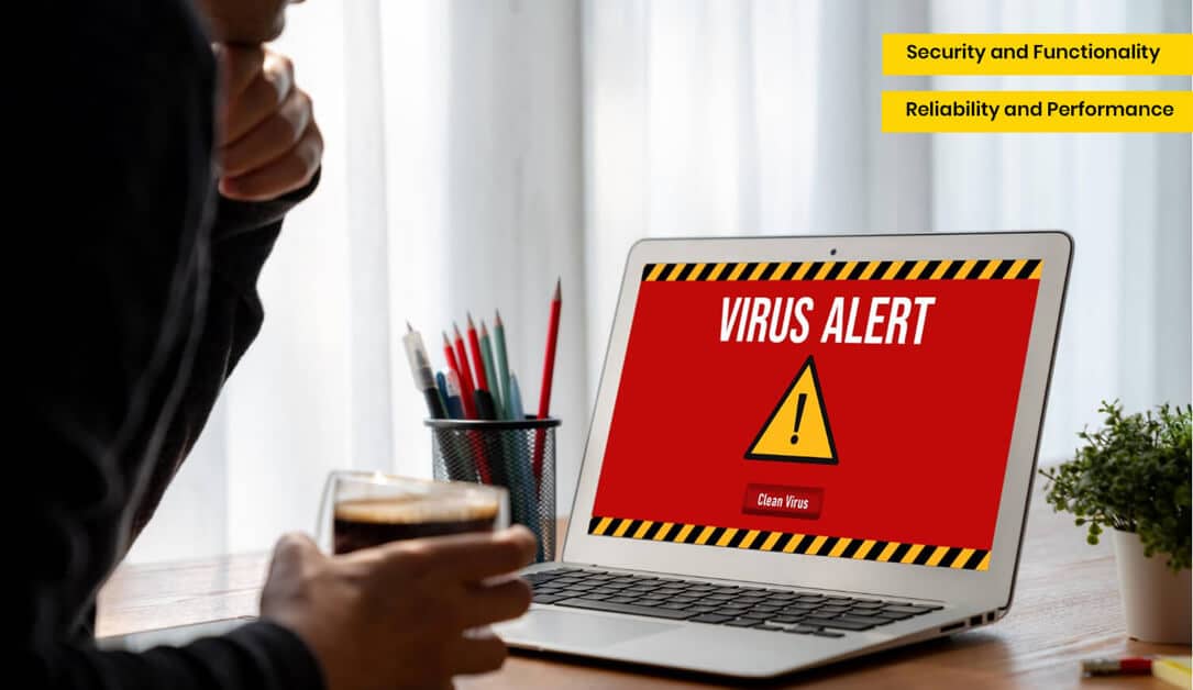 Person holding a glass while looking at a laptop displaying a red "VIRUS ALERT" message, emphasizing the importance of website security and maintenance in preventing cyber threats.